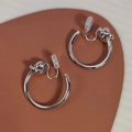 Silver-tone twisted hoop clip-on earrings for non-pierced ears with polished metal finish - Silver Twist Ear Clip