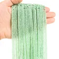 Macro shot of 3mm faceted mint green natural stone beads held in hand for detail - 3mm (38cm, Approx. 120 Beads) / Prehnite