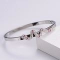 Macro shot of polished silver snake bracelet with pave-set pink and white crystals - Silver