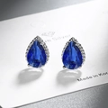 Close-up of teardrop dark blue zircon earring with silver beaded edge on a display card - Royal Blue Zirconia