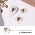 Macro detail of ice-clear white resin bow nail charms with iridescent heart rhinestones - Clear White