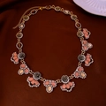Macro shot of vintage gold flower necklace with pink gems on dark velvet background - 35# Gold Necklace Royal Flower