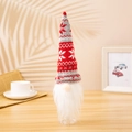 Detail of Christmas gnome wine bottle cover with red knitted snowflake hat and white beard - Red and Grey Snowflake Style
