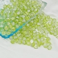 Macro shot of 6mm and 8mm green crackle glass beads scattered on white textured fabric - 8mm / Light Green