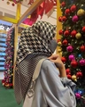 Detail of satin headscarf with houndstooth and star patterns worn near a Christmas tree - Large Houndstooth
