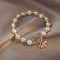 Detail of baroque pearl bracelet with gold beads and a sparkling bee charm on silk - 8# Bracelet-Gold-Bee
