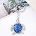 Detailed view of silver turtle keychain with blue glitter inlay and metal spring clip - Turtle 19 (Blue Drip Glue)