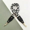 Detail of adjustable leopard print bag strap with gold rivets and metallic hook hardware - Grayish White