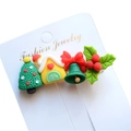Detailed view of resin Christmas hair clips featuring festive trees and bells on card - Style 4 Christmas Hair Clip