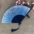 Blue gradient folding fan with white floral patterns and matching dark blue tassel - No.03 Blue Gradient Floral Hollow