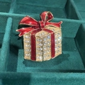 Golden gift box Christmas brooch with red enamel bow and sparkling rhinestones - Red Christmas Gift Box Brooch