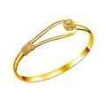 Detailed view of golden open bracelet featuring intricate rose flower and woven patterns - Gold