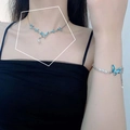 Blue butterfly jewelry set with pearls including necklace and bracelet on model - Butterfly Necklace and Bracelet Set (L0004X)