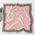 Detailed view of pink silk scarf with black striped borders and horseshoe patterns - 70*70cm / Light Pink