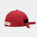 Detail of red miki hat showing How do you do patch and golden metal ring ornament - Adjustable / Ring Letter Patch Dark Red