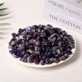 Natural purple amethyst tumbled crystal stones displayed on a decorative white plate - Amethyst (9-12mm) 100g