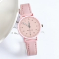 Close-up of a pink quartz watch with leather strap and minimalist numerical dial - Pink