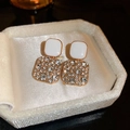 Roze hart oorknopjes met wit hars en gouden accenten in een beige fluwelen sieradendoos - Wit vierkant (Stalen pin) / Goud Wit