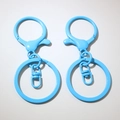 Close-up of light blue painted metal lobster clasps and flat key rings for DIY jewelry - Blue (Painted)