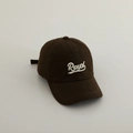 Detailed view of Royal embroidered logo on dark brown cotton baseball cap for kids - 52-54cm (3-8 Years) / Brown