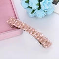 Detail of pink crystal beaded spring hair clip resting on a pink velvet jewelry box - Pink