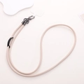 Detail of beige PU leather phone lanyard with dark grey metal clips and adjuster - Crossbody / Beige