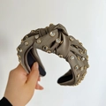 Detail of grey knotted satin headband featuring sparkling rhinestones and black lining - Olive Green