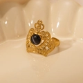 Detailed close-up of crown shaped gold titanium ring with round black gemstone - Black Gem-Gold
