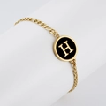 Golden chain bracelet featuring a black enamel charm with a 3D gold H letter detail - Letter H / Gold/Black
