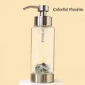 Glass dispenser bottle with silver pump and base filled with colored fluorite crystals - Rainbow Fluorite
