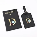 Detail of black PU leather passport holder and luggage tag set with golden letter D - Black Letter D