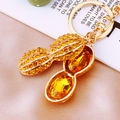 Golden peanut keychain pendant with amber rhinestones and crystal detail inside - Yellow Rhinestone Peanut