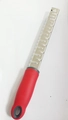 Red stainless steel lemon zester and cheese grater with ergonomic handle for kitchen use - Cross Texture Red