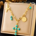 Detail of gold cross pendant necklace with turquoise stones and Saint Benedict medal - Turquoise Cross Coin (N3166)