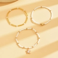 Three-piece bohemian anklet set featuring white seed beads, starfish, and shell charms - Three-Piece Set