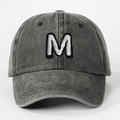 Vintage washed charcoal baseball cap featuring white embroidered letter M and curved brim - Letter M