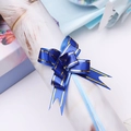 Macro view of a royal blue pull bow ribbon with gold edges for gift box decoration - Royal Blue Gold Edge