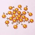 Macro shot of orange and yellow daisy flower pendants for DIY jewelry making - Orange & Yellow