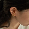 Minimalist gold wave ear cuffs with geometric irregular design shown on model's ear - Ear Cuff (EL6005) / Gold