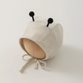 Close-up of baby ribbed cotton earflap hat with cute black pom-pom bee antennae - 35-45cm 0-12 Months / Beige