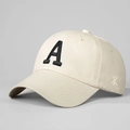 Detail of embroidered letter A on cream cotton twill baseball cap with curved brim - Beige