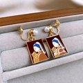 Macro shot of gold enamel clip earrings featuring girl with a pearl earring cat parody - 58# Earring Clip - Gold