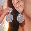 Luxurious silver flower cluster earrings with sparkling white crystals on model - Silver Large Flower Cluster Style