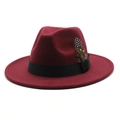 Close-up of burgundy fedora hat featuring a black ribbon band and pheasant feather detail - Burgundy