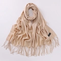 Detail shot of beige 100% cashmere scarf featuring soft texture and elegant fringe edges - Rice Camel