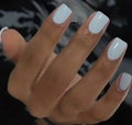 Close-up of glossy light blue square press-on nails on fingers with dark background - Light Blue (CW195)