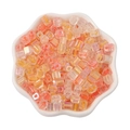 Iris orange pink glass cube beads in a white bowl for DIY bracelet making - Orange Yellow Mix