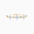 Close-up of golden 18K ring with light blue flowers and zircon stones on white background - Blue Flower-Gold