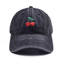 Vintage washed black baseball cap with cherry embroidery and curved brim in 45-degree view - Black