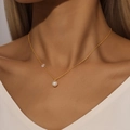 Close-up of gold-plated Y-shaped necklace with white freshwater pearl and small zircon - Gold Choker-Pearl and Zirconia Pendant